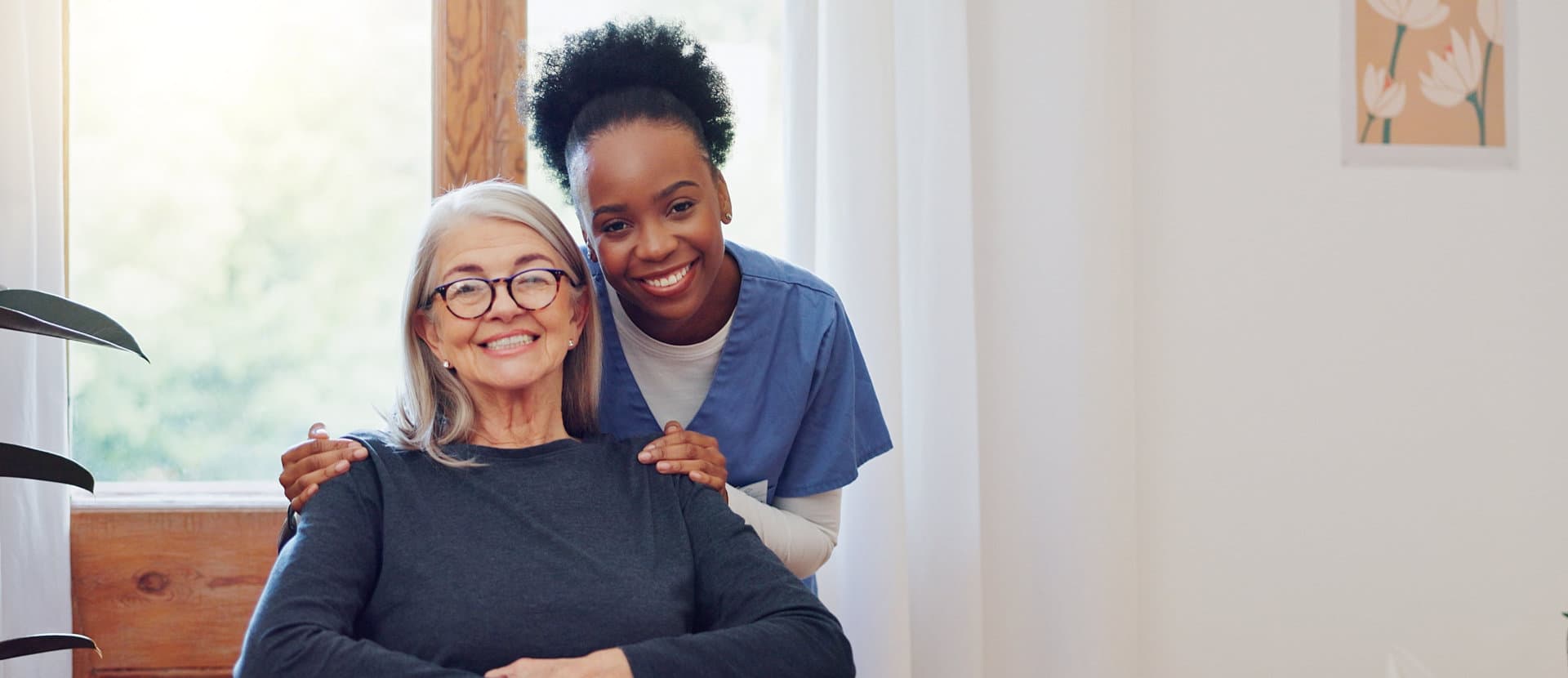 aide and elderly woman smiling